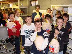 Boy Scout troops filling the shelves of our Food Pantry